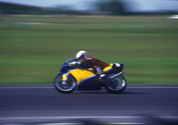 A motor cycle race with speeding bikes and high speed cornering