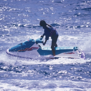 A man enjoying the sunshine on a water scooter