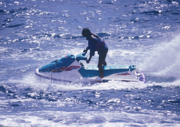 A man enjoying the sunshine on a water scooter