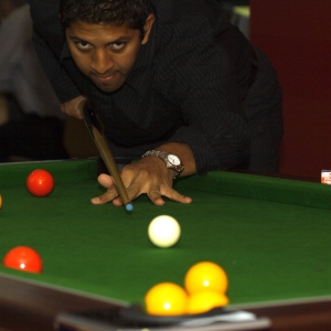 a man playing pool in a bar