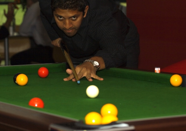 a man playing pool in a bar