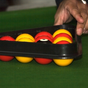 Setting up a game of pool on a table