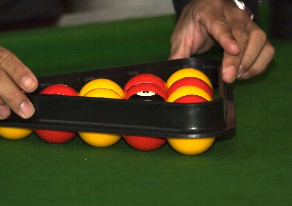 Setting up a game of pool on a table