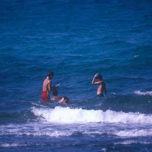 Children playing in the sea on a hot sunny day