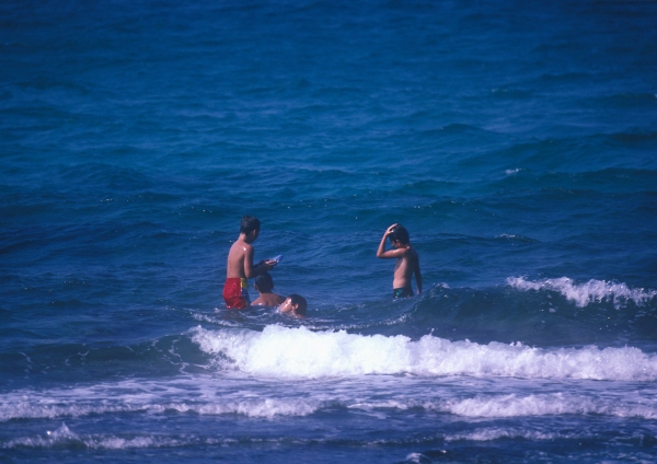 Children playing in the sea on a hot sunny day