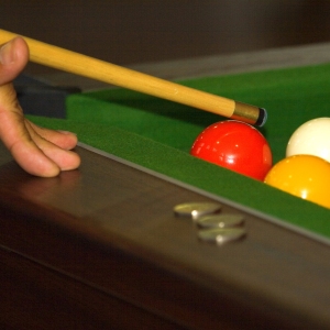 Close up of a game of pool in progress in a bar