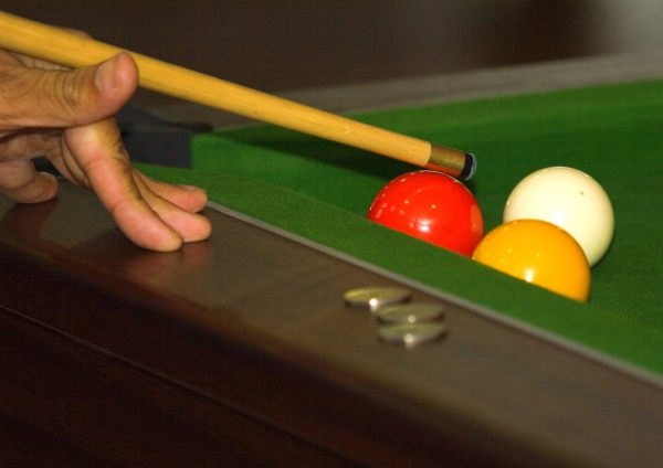 Close up of a game of pool in progress in a bar