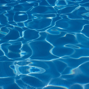 a background image of the water in a blue swimming pool