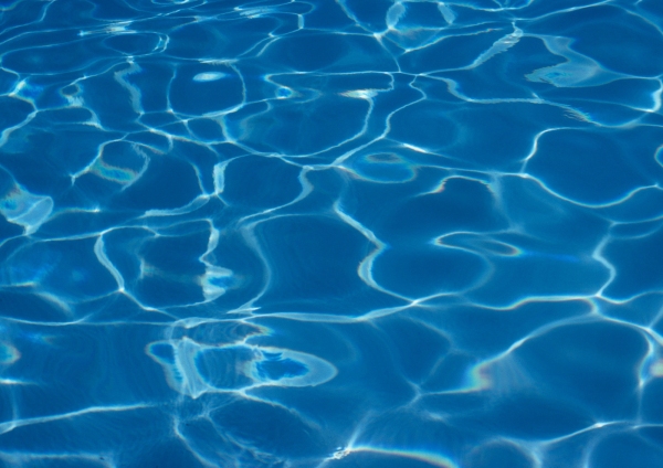 a background image of the water in a blue swimming pool