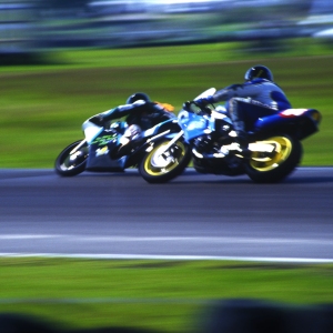 Speeding motorbikes cornering in a race