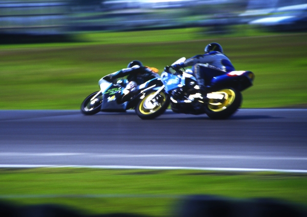 Speeding motorbikes cornering in a race