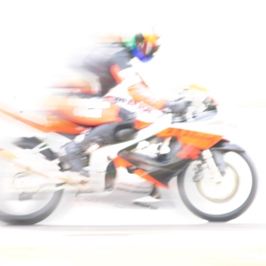 A high key image of a racing motorcyclist