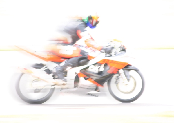 A high key image of a racing motorcyclist