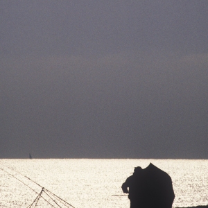 Two anglers sea fishing from a beach