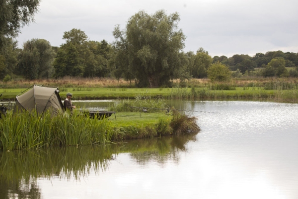 Carp fishing on a perfectly still lake on a summer's evening