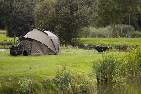 A carp fisherman's bivvy by a lakeside in summer