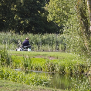 A fisherman watching his float with an electric buggy for his fishing tackle