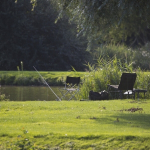 Coarse or float fishing tackle on the bank of a lake on a summer's evening in suffolk, england