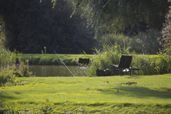 Coarse or float fishing tackle on the bank of a lake on a summer's evening in suffolk, england