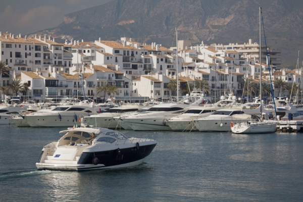 A luxury yacht sailing into the harbour at Puerto Banus, Andalusia on the Costa del Sol in Southern Spain