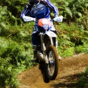 Motocross rider struggling to control his bike in a race