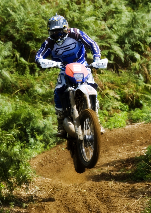 Motocross rider struggling to control his bike in a race