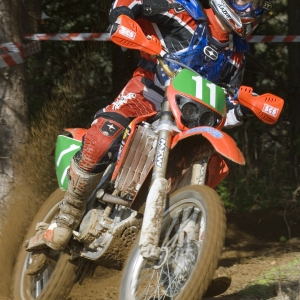 A motocross rider cornering at speed