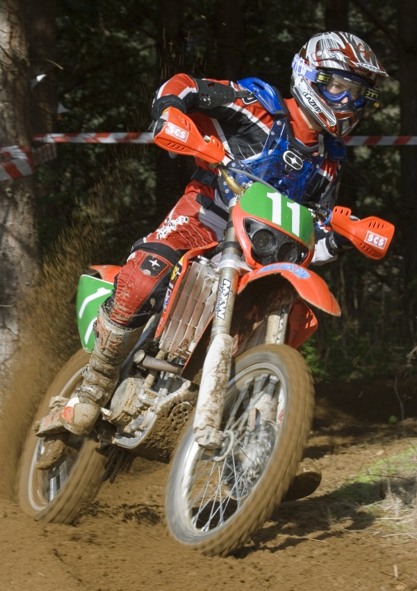 A motocross rider cornering at speed