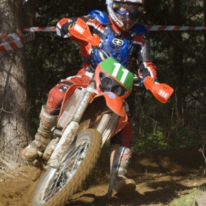 A motocross rider cornering at speed