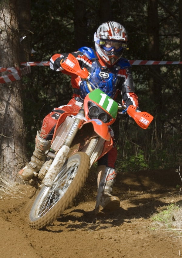 A motocross rider cornering at speed