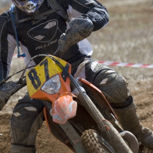 A motocross rider cornering at speed