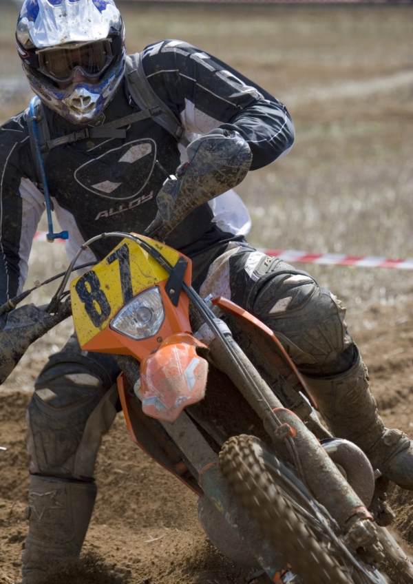 A motocross rider cornering at speed