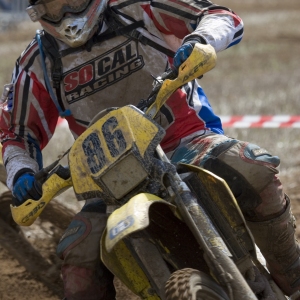 An extreme close up of a motocross rider in a race