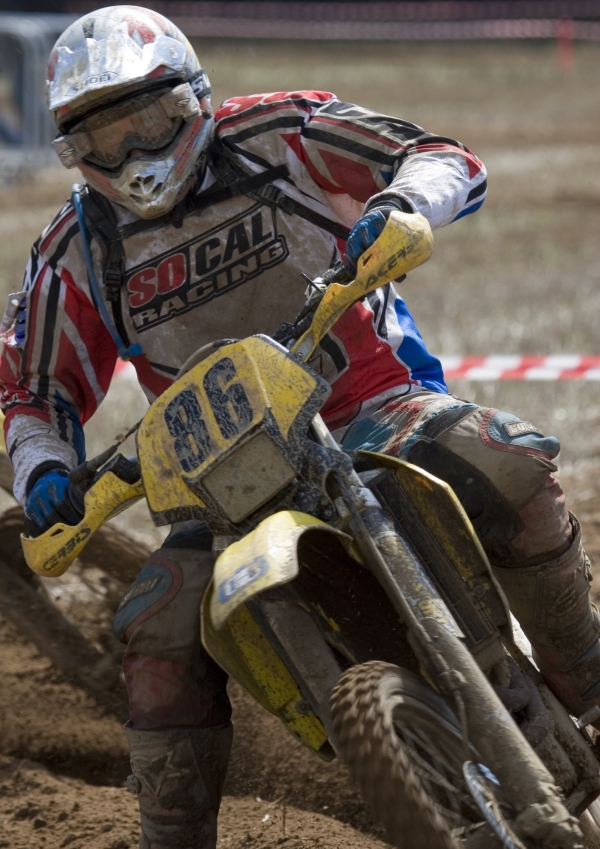 An extreme close up of a motocross rider in a race