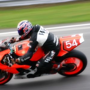 A motorcycle cornering at high speed on a track