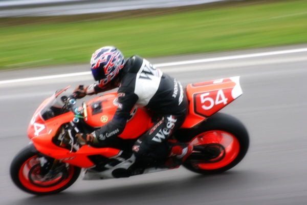 A motorcycle cornering at high speed on a track