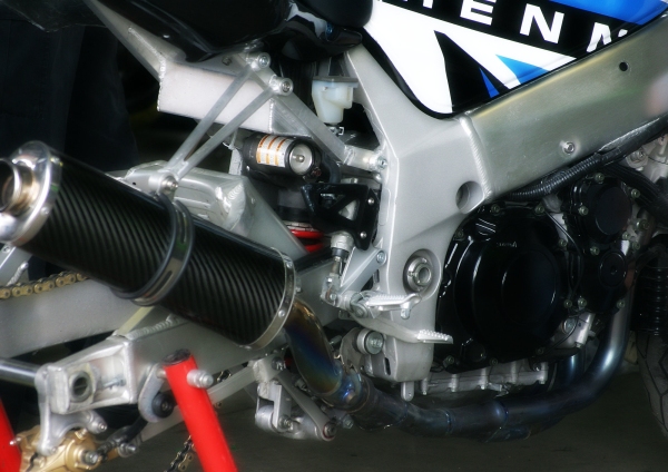 A close up image of the engine of a racing motorbike