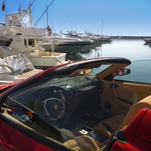 The marina at Puerto Banus in Southern Spain, with a red Ferrari in the foreground