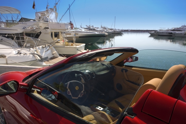 The marina at Puerto Banus in Southern Spain, with a red Ferrari in the foreground