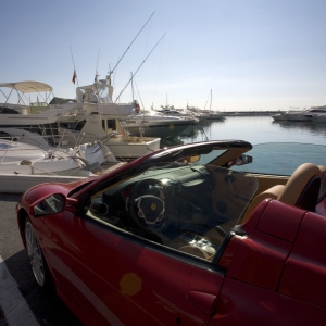 The marina at Puerto Banus in Southern Spain, with a red Ferrari in the foreground