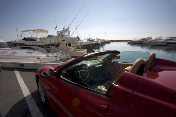 The marina at Puerto Banus in Southern Spain, with a red Ferrari in the foreground