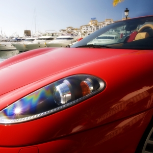 The marina at Puerto Banus in Southern Spain, with a red Ferrari in the foreground