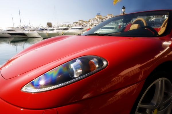 The marina at Puerto Banus in Southern Spain, with a red Ferrari in the foreground