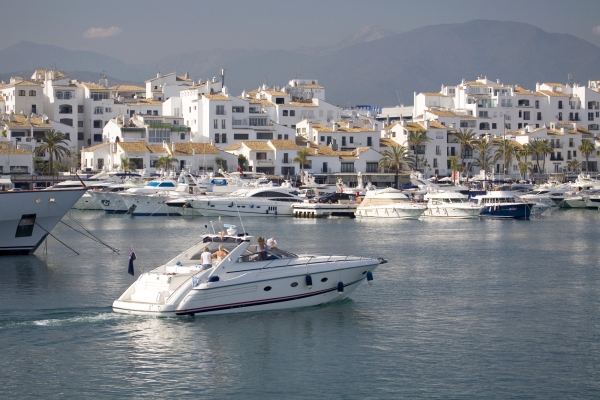 A luxury motor boat entering the harbour at Puerto Banus