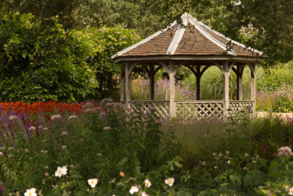 A pavilion in an English country garden in high summer