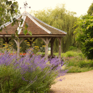 A pavilion in an English country garden in high summer